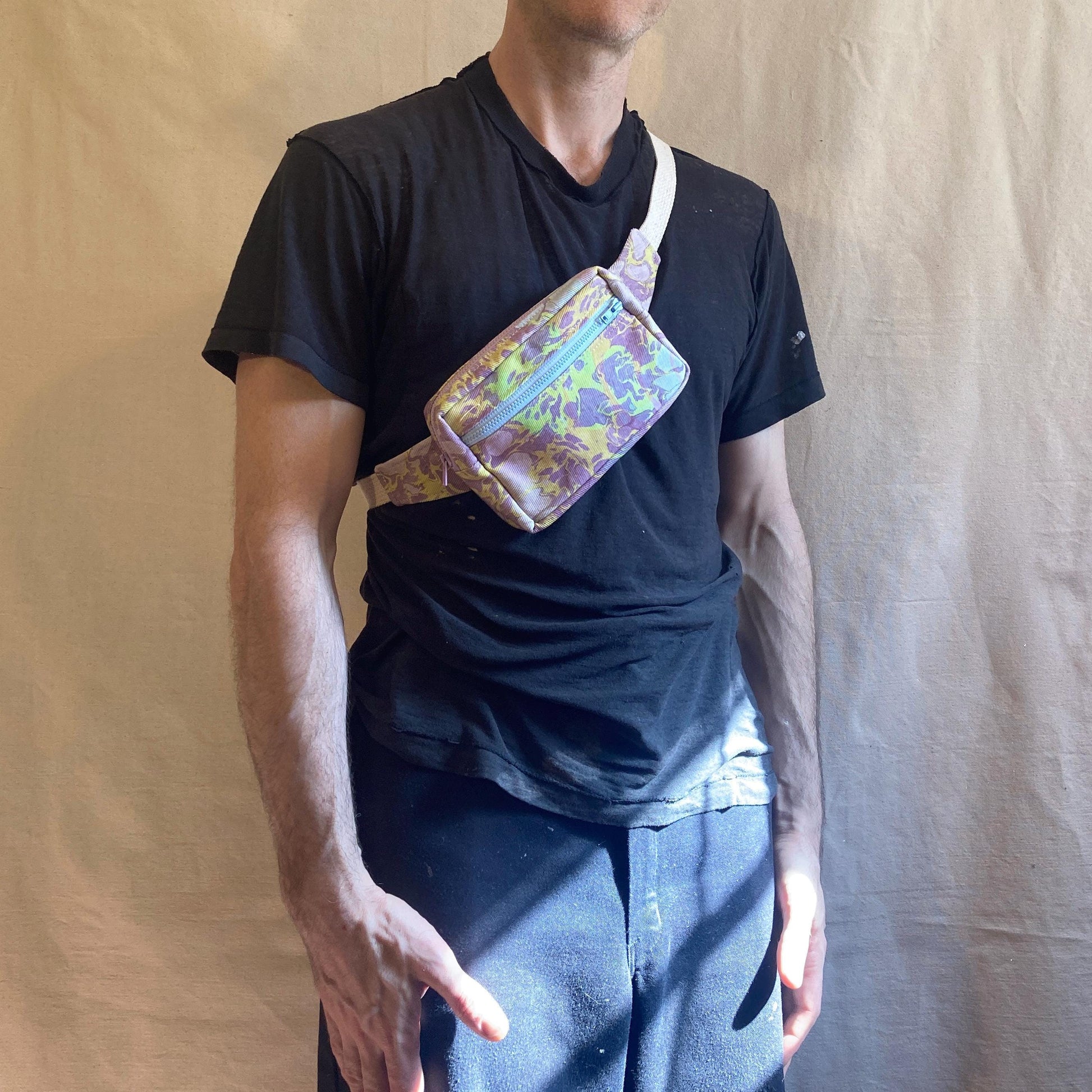 Person modelling a water marbled fanny pack