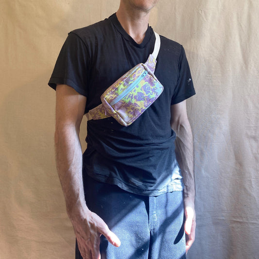 Person modelling a water marbled fanny pack