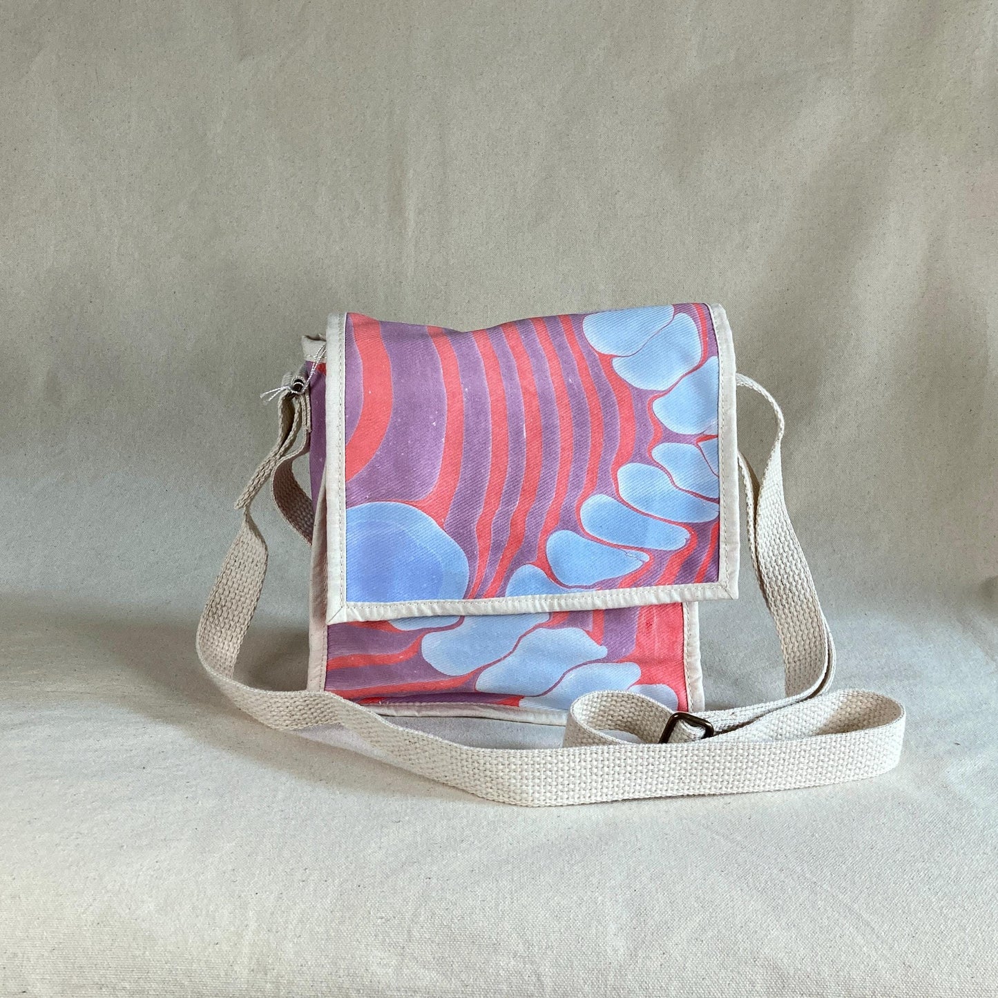 A mini square water marbled messenger bag with a flap