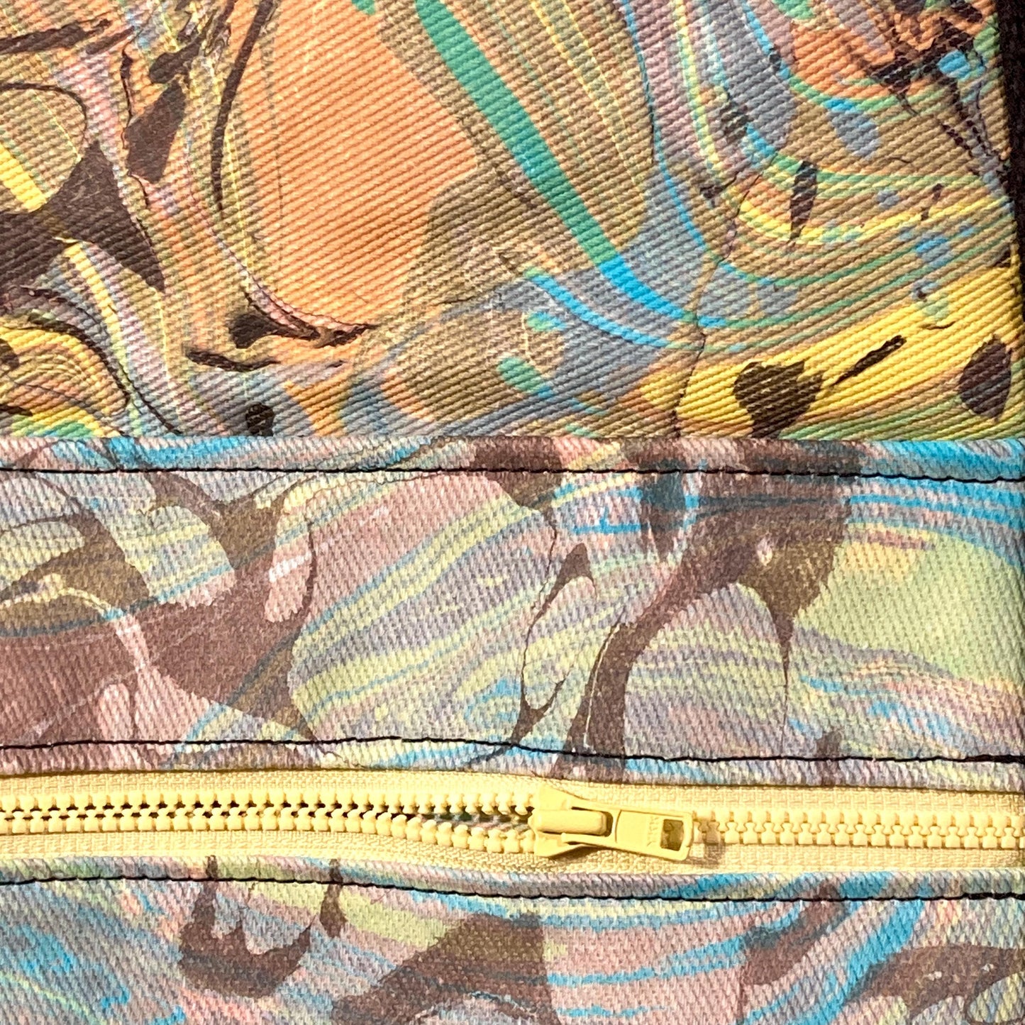 Close up of an oversized water marbled tote bag with contrasting straps