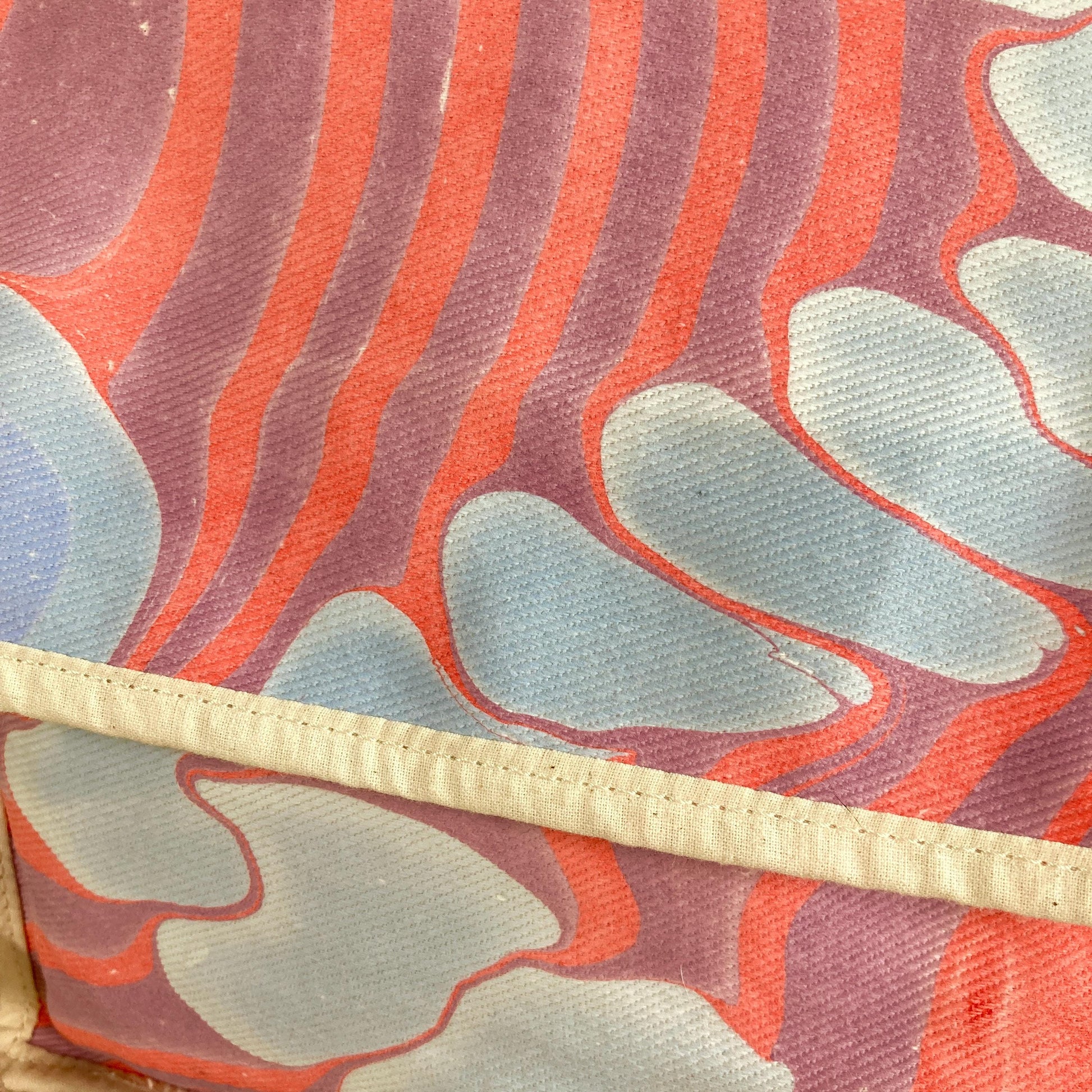 Close up of a mini water marbled messenger bag